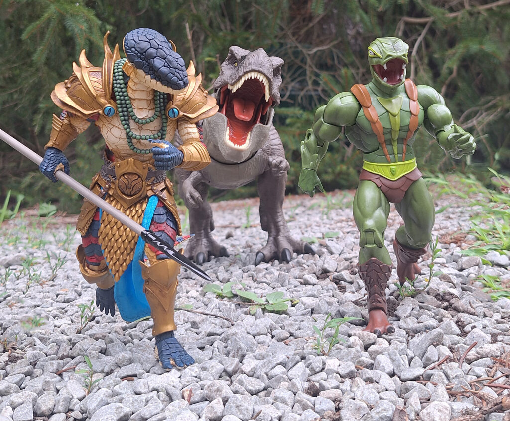 Kobra Khan, Varnakk, and a roaring T-Rex running forward through rocky terrain in comic book style.