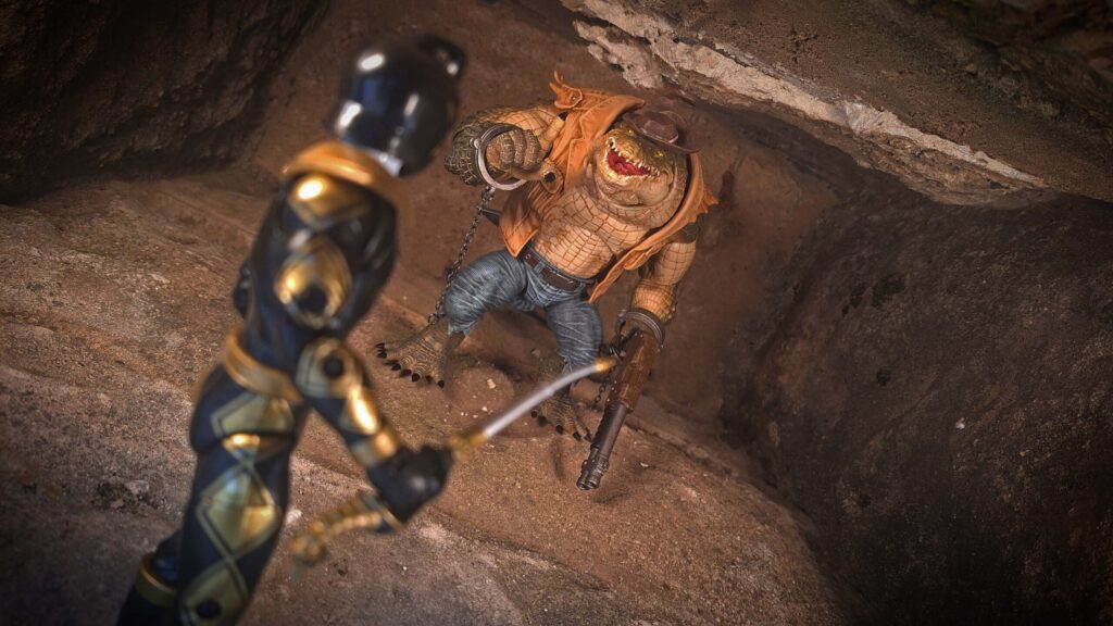 Black Dino Ranger stands ready as the Croc Hunter emerges inside the cavern in a dramatic face-off.