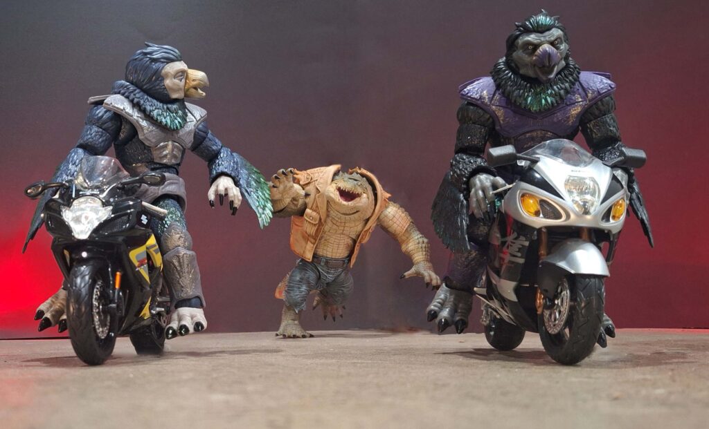 Two Tenga Warriors riding sport bikes chased by an enraged Croc Hunter in a gritty comic-book fantasy illustration.