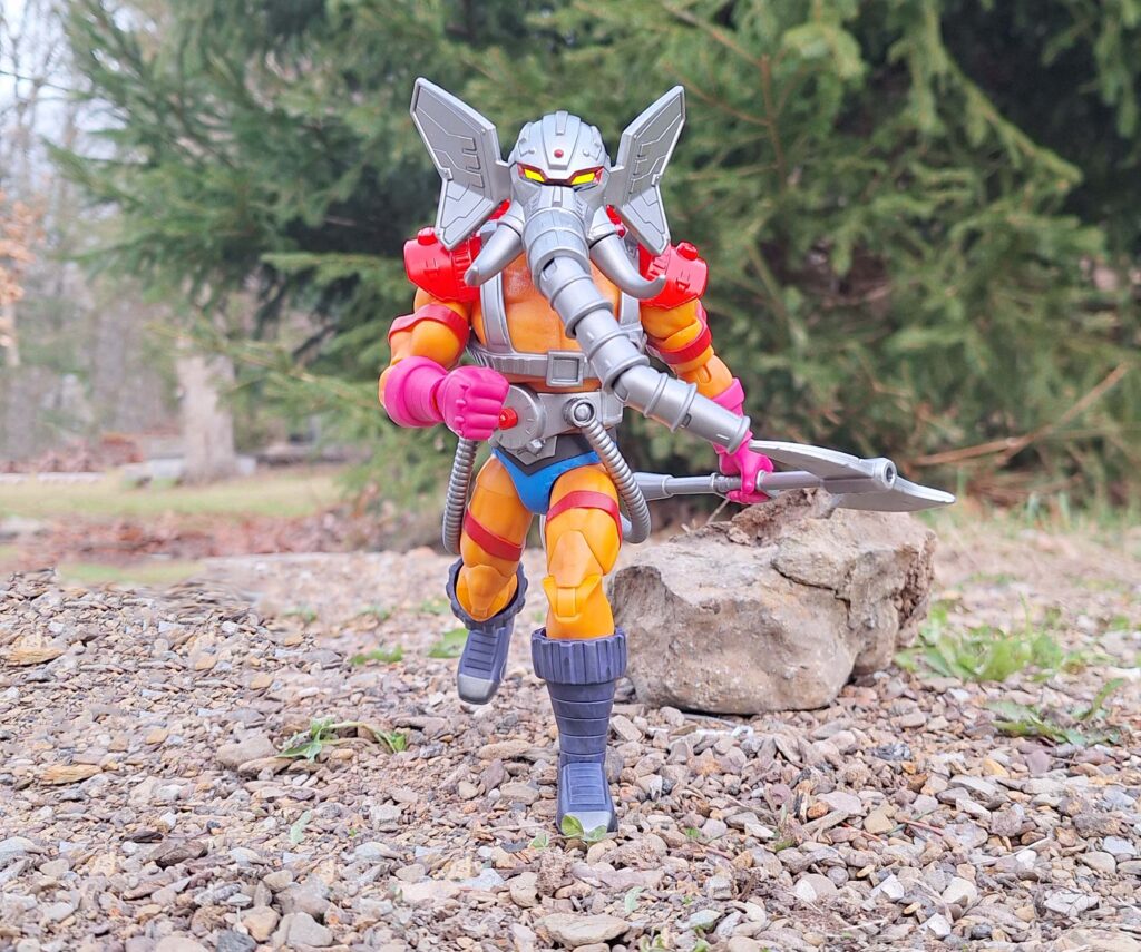 Snout Spout firefighter story scene, with Snout Spout running along a rocky Eternian creek bed toward smoke in the distance, water pack on his back and axe in hand.